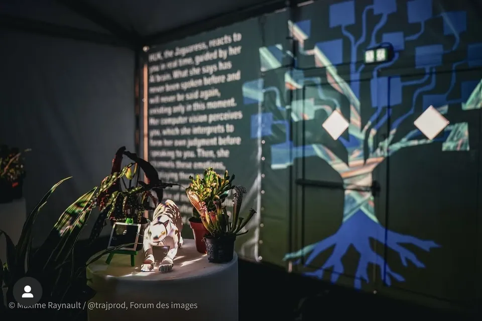 Un árbol proyectado con raíces azules junto a un muro de texto, y una figura blanca de jaguar entre plantas.
